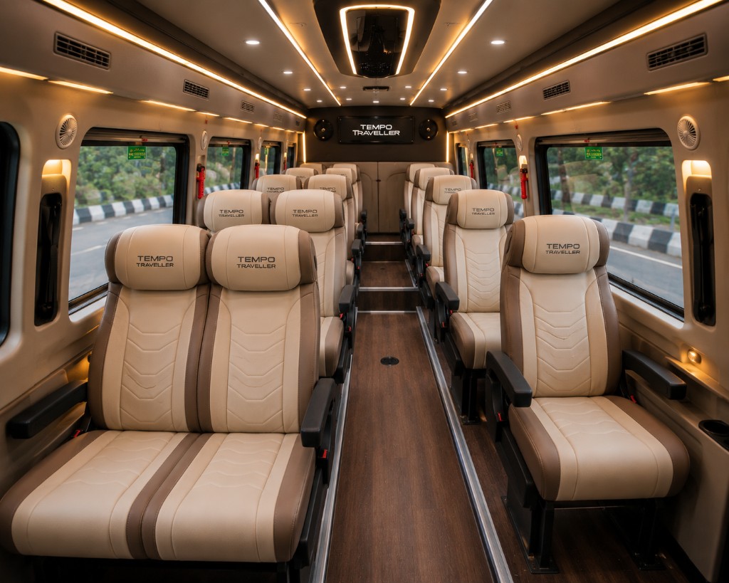 Premium Tempo Traveller luxury vehicle interior with plush reclining seats and ambient lighting